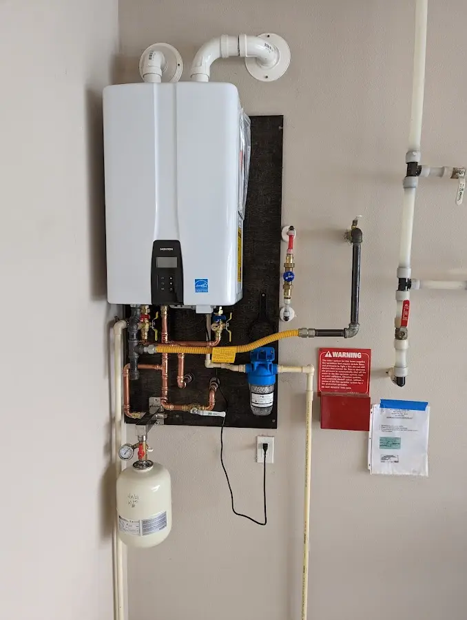 Professional plumber installing copper piping in a Medford Lakes home